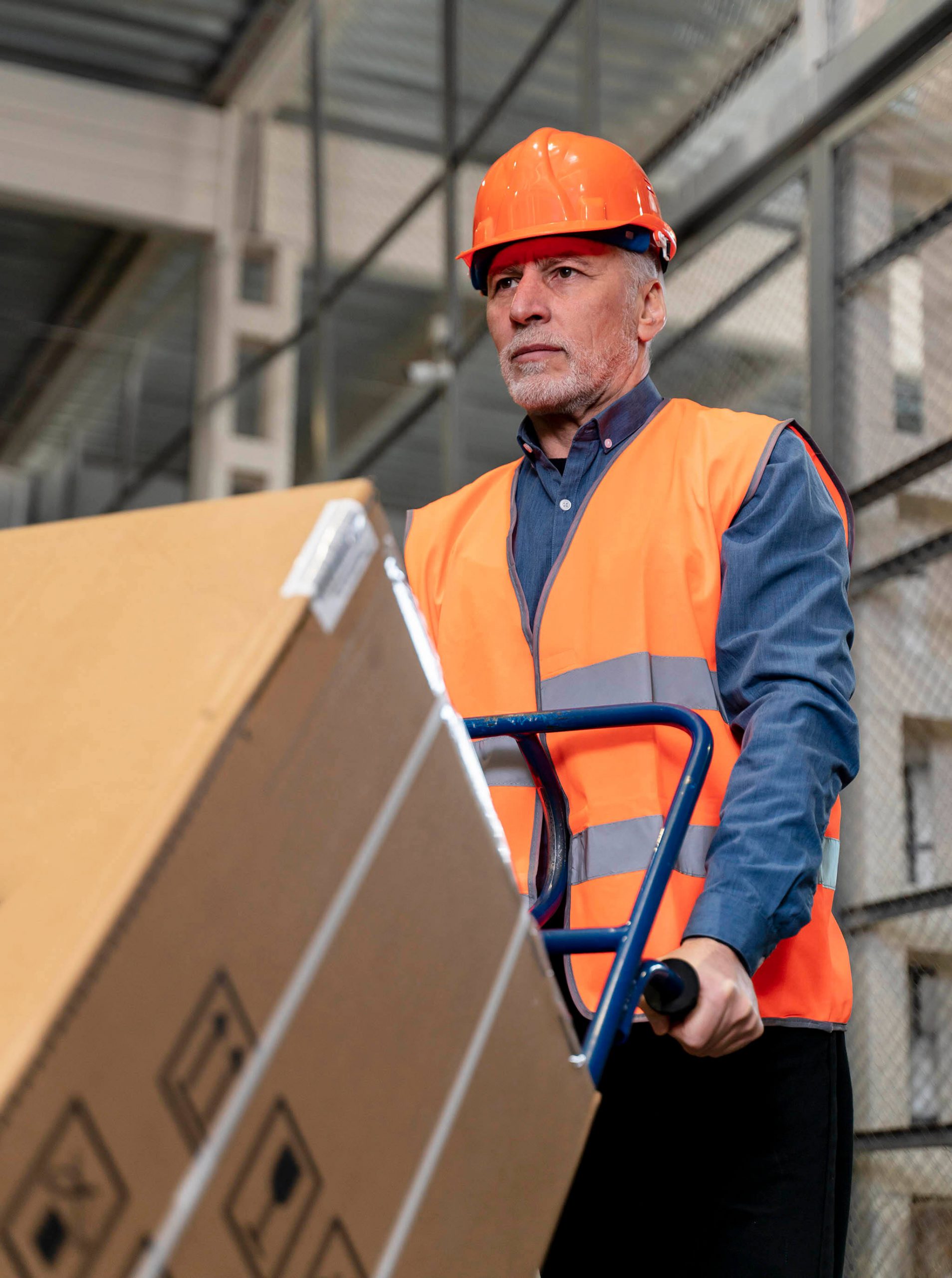 man-with-helmet-carrying-boxes